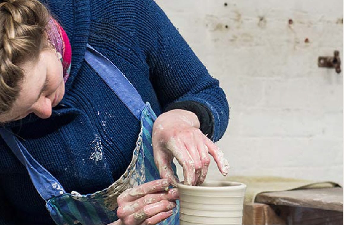 Woman making clay pot